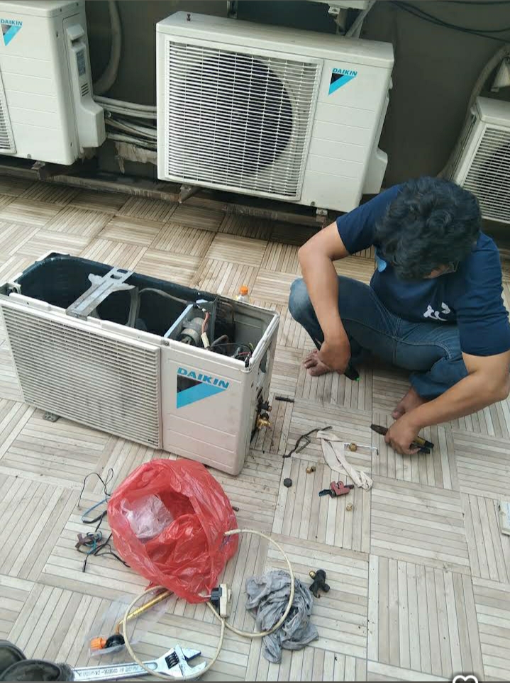 Teknisi memperbaiki outdoor AC